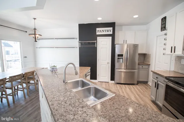 a kitchen with a refrigerator and a sink