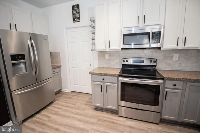 a bathroom with a tub shower and sink