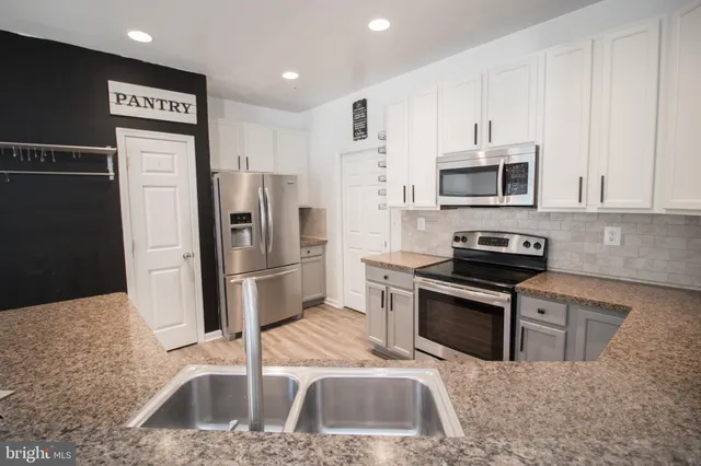a bathroom with a granite countertop sink mirror and double