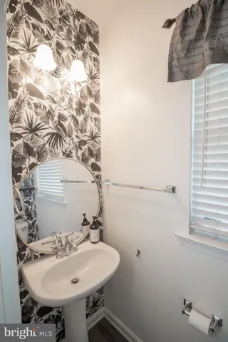 a bath tub sitting in a bathroom next to a window