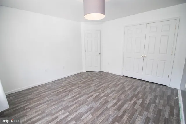 a view of an empty room with a closet
