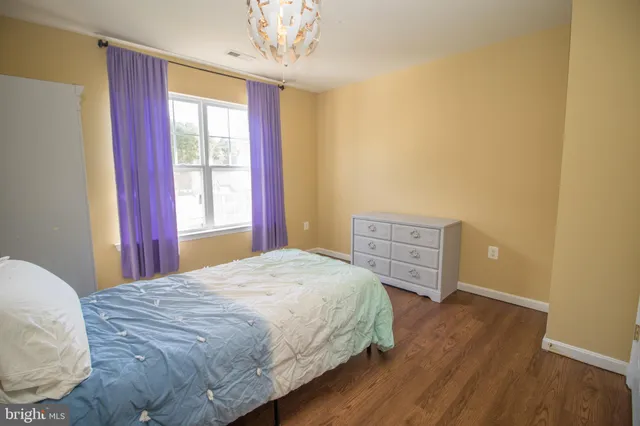 a view of a house with backyard and a tree
