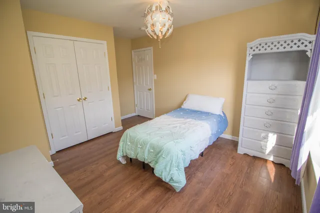 a view of a house with a backyard and a wooden deck