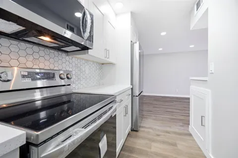 a kitchen with a stove and a microwave