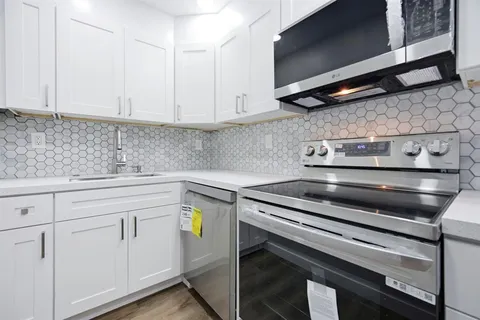 a kitchen with appliances cabinets and a counter top space