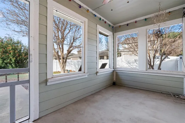 a backyard of a house with a large tree
