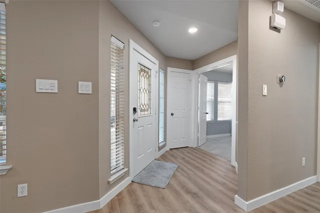 an empty room with closet and a chandelier fan