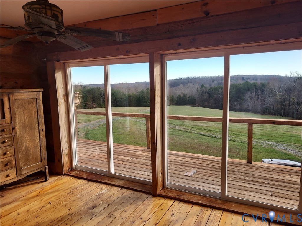 6430 River Road West Columbia, VA 23038 - Photo 24 of 48 a view of a deck with a floor to ceiling window wooden floor and a yard