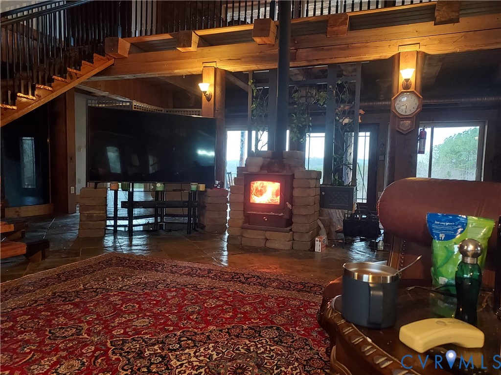 6430 River Road West Columbia, VA 23038 - Photo 35 of 48 a room with lots of furniture a chandelier and potted plants