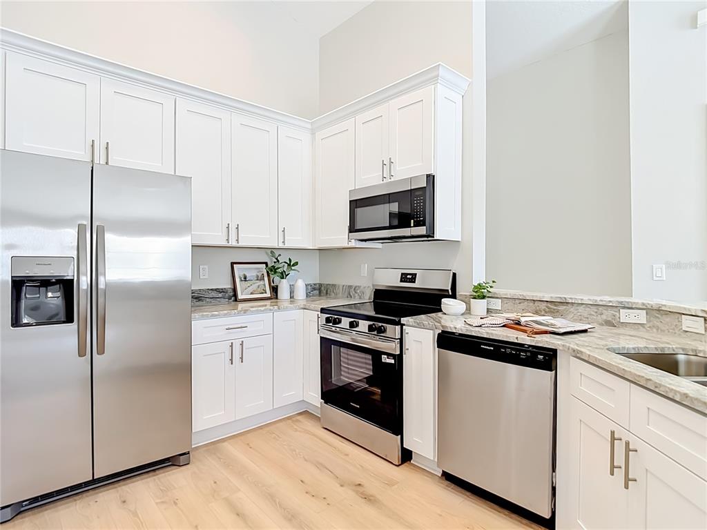 5310 Anhinga Trail New Port Richey, FL 34653 - Photo 6 of 27 a kitchen with a sink stove and refrigerator
