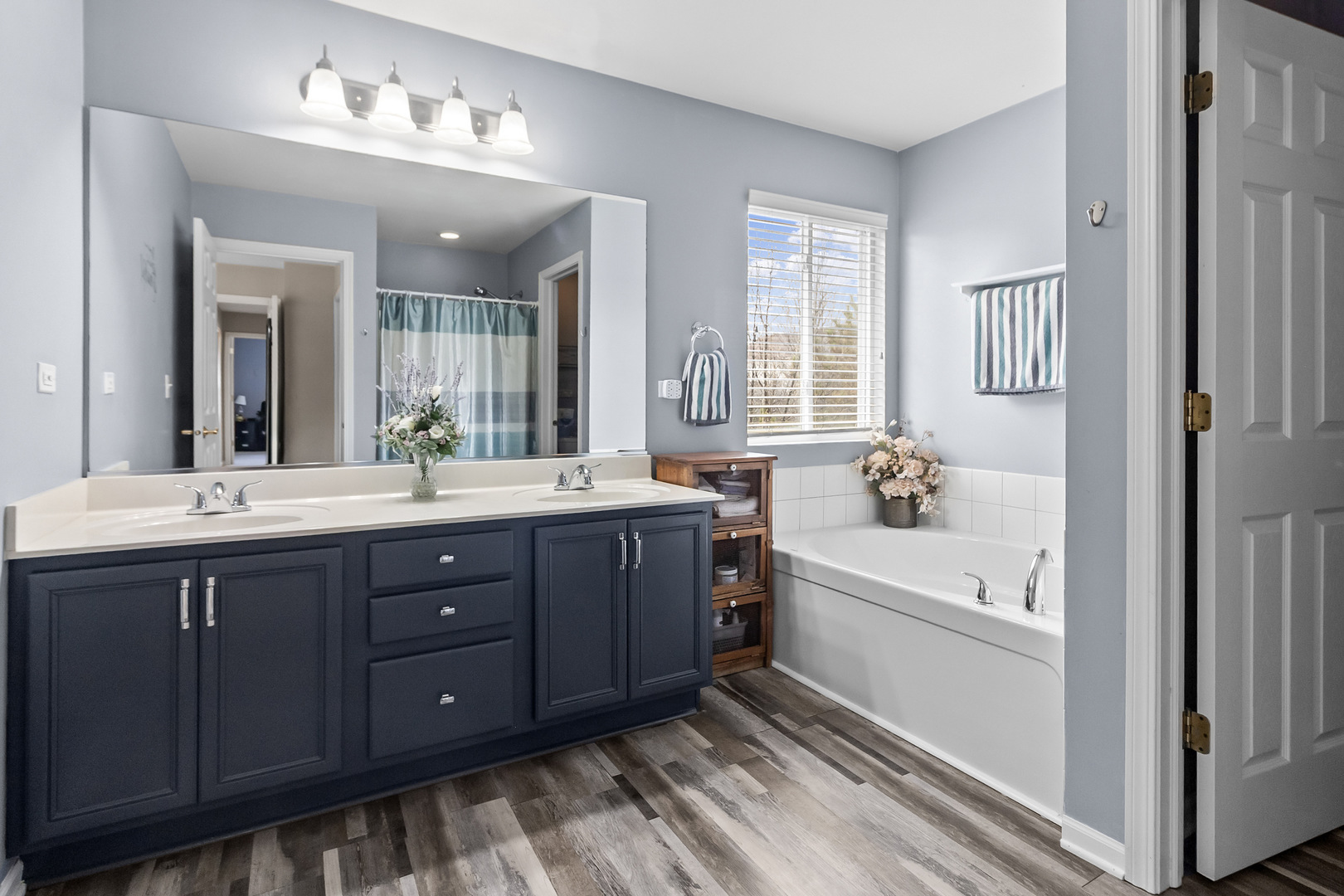362 Keswick Circle Round Lake, IL 60073 - Photo 13 of 27 a spacious bathroom with a tub double sink window and mirror