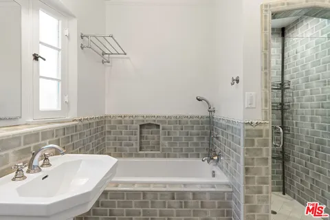 a bathroom with a bathtub and shower