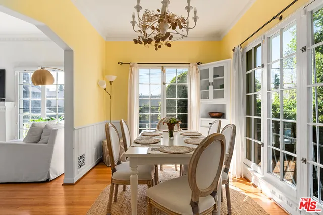 a view of a dining room with furniture wooden floor and chandelier
