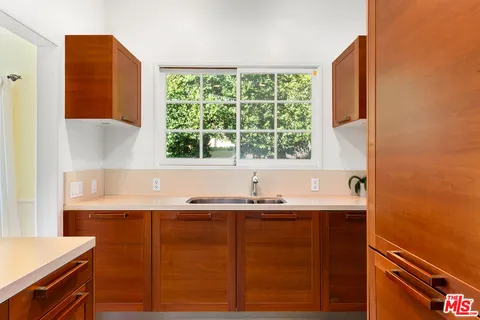 a view of a kitchen with a sink and a window