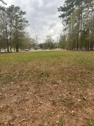 a view of outdoor space with green field and trees all around
