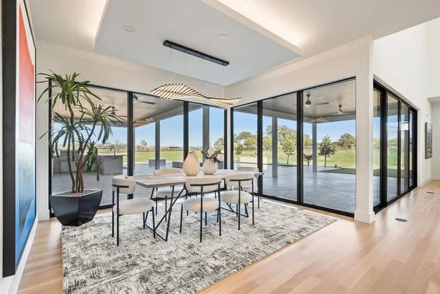 a dining room with furniture a chandelier and wooden floor