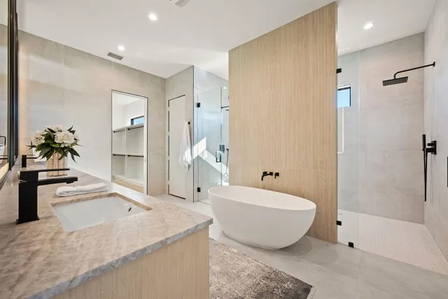 a spacious bathroom with a tub and shower