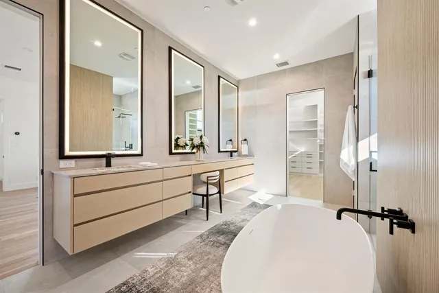 a en suite bathroom with a double vanity sink a mirror and a shower