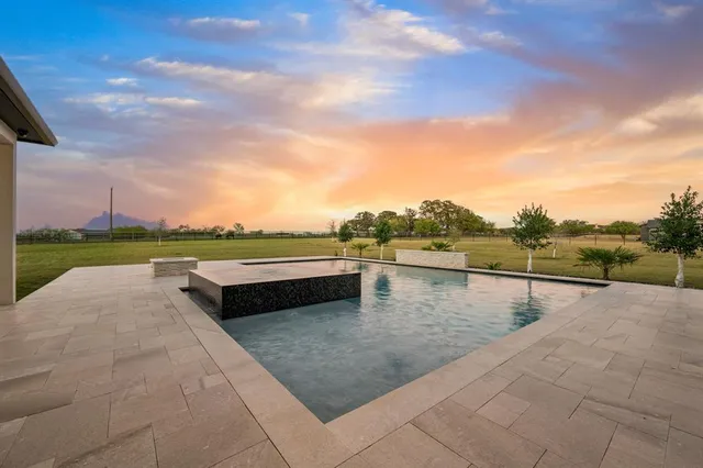 a view of swimming pool with a table and chair