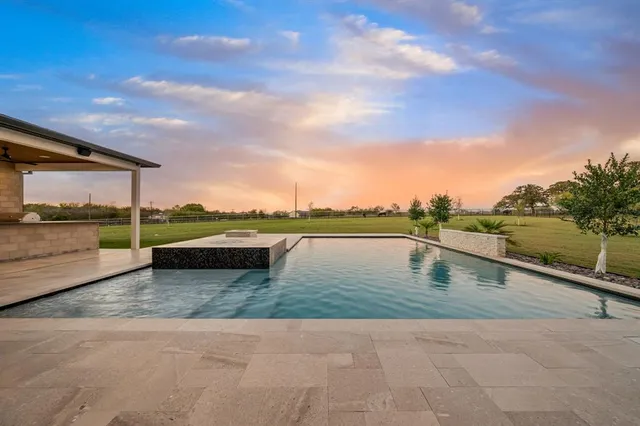 a view of swimming pool with a lounge chair