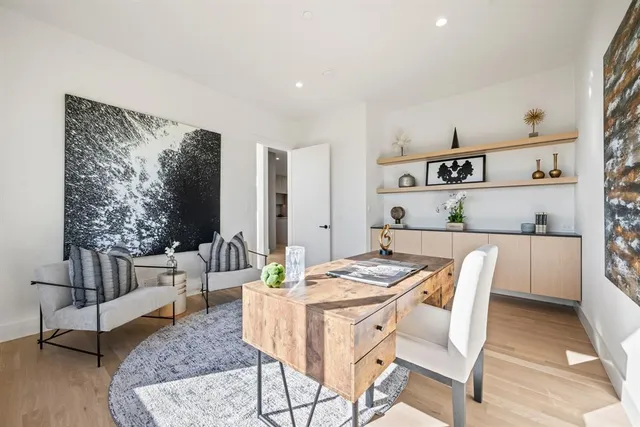 a dining room with furniture and a rug