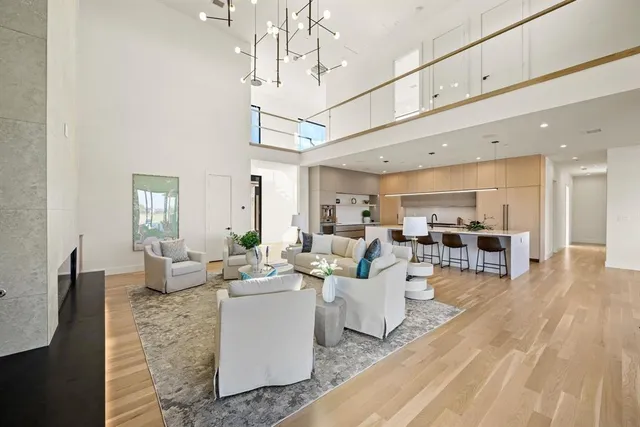 a living room with lots of furniture and kitchen view