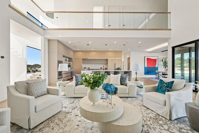 a living room with furniture and a dining table