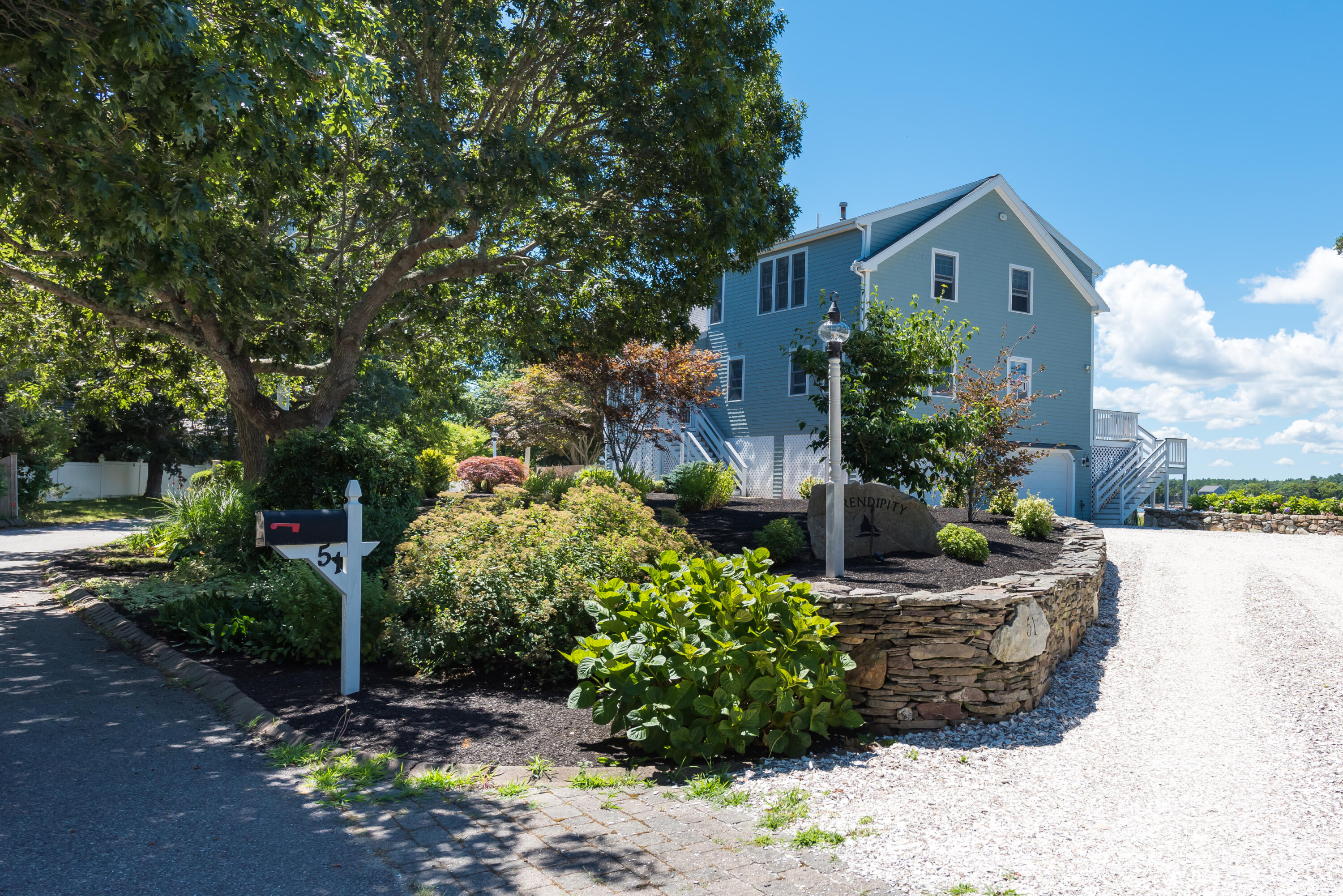 51 Robinwood Road Buzzards Bay, MA 02532 - Photo 2 of 27 a front view of a house with a yard and outdoor seating