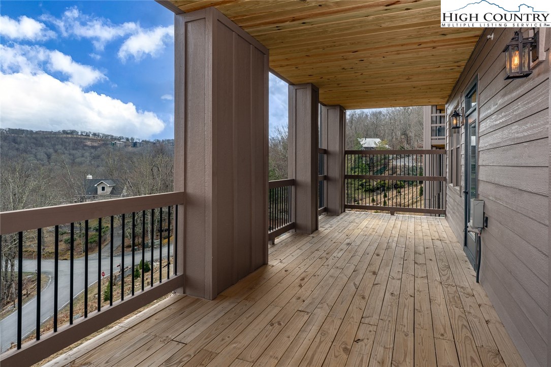 240 Ridgeline Drive, Unit D Sugar Mountain, NC 28604 - Photo 25 of 30 a balcony with wooden floor