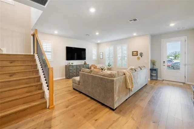 a spacious bedroom with a bed and a flat screen tv