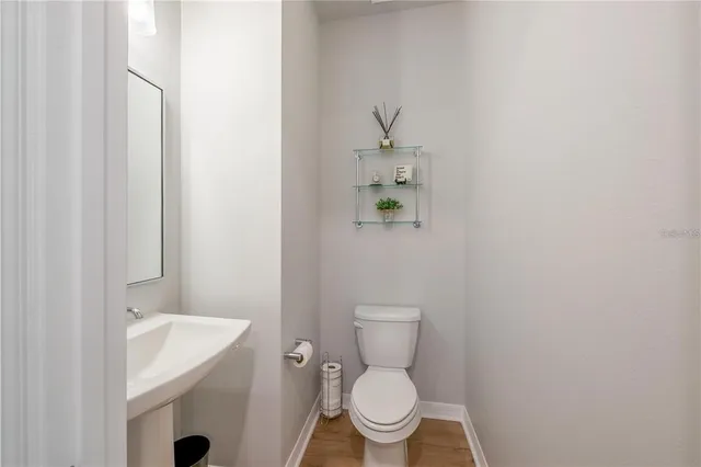 a white toilet sitting next to a bathroom sink