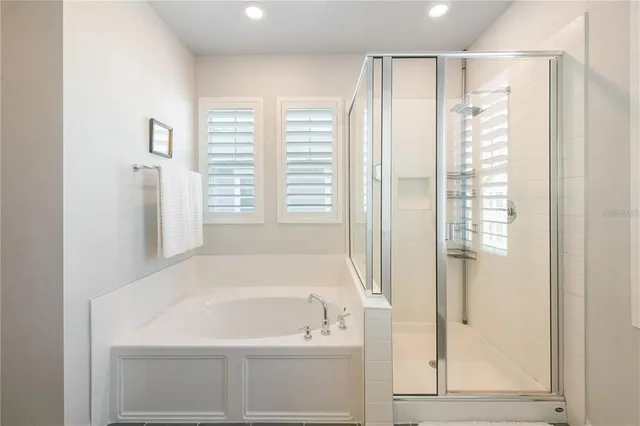 a bathroom with a bathtub and a shower