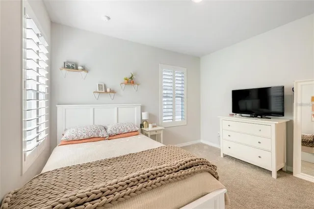 a bedroom with a bed and flat screen tv