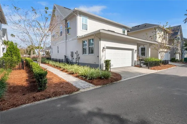 a front view of a house with a yard and outdoor seating
