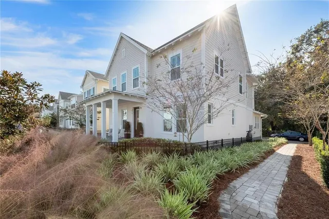 a front view of a house with a yard and fountain in middle