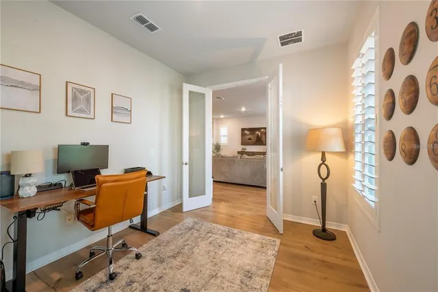 a view of a workspace with furniture and a window