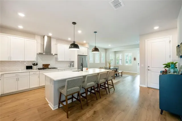 a large kitchen with kitchen island a sink table and chairs