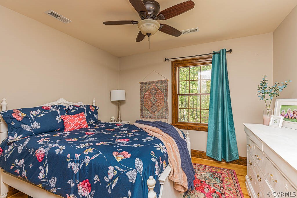 2090 Strawberry Run Crozier, VA 23039 - Photo 35 of 47 a bedroom with a large bed and a chandelier fan