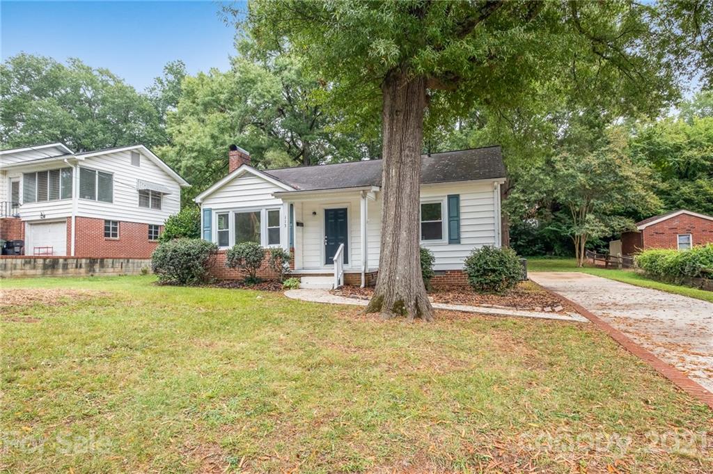 113 Hillside Avenue Southwest Concord, NC 28025 - Photo 2 of 19 a front view of a house with a garden and trees