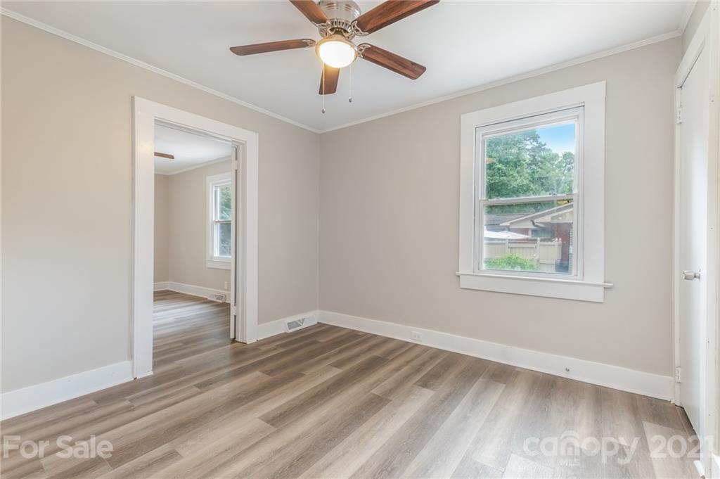 113 Hillside Avenue Southwest Concord, NC 28025 - Photo 12 of 19 a view of an empty room with wooden floor and a window