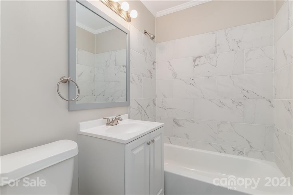 113 Hillside Avenue Southwest Concord, NC 28025 - Photo 13 of 19 a bathroom with a sink a toilet and shower