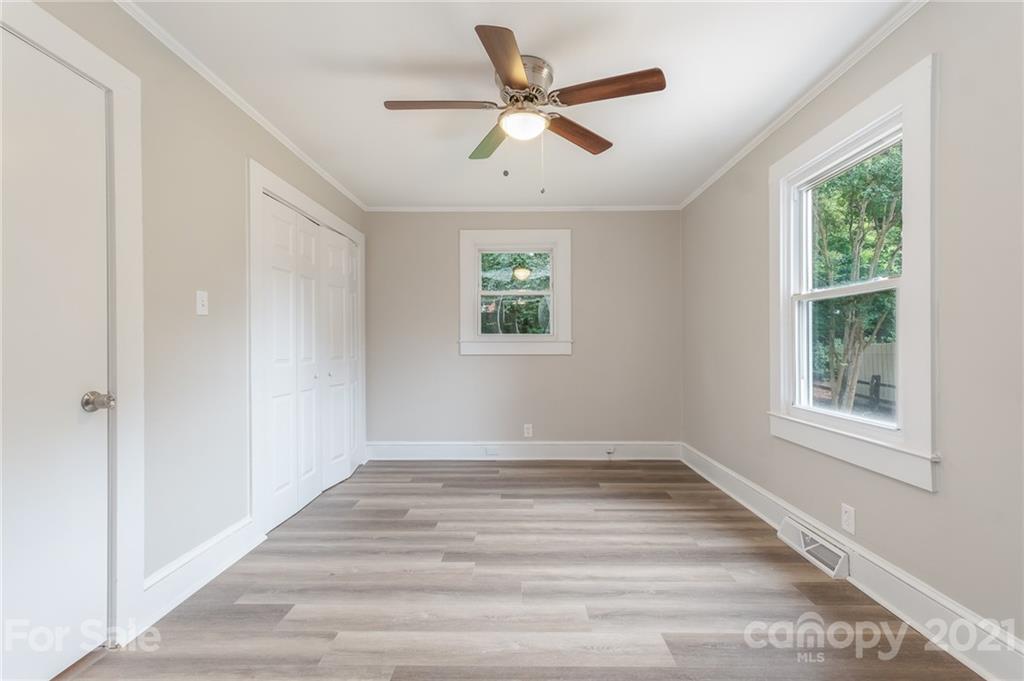 113 Hillside Avenue Southwest Concord, NC 28025 - Photo 14 of 19 an empty room with windows and ceiling fan