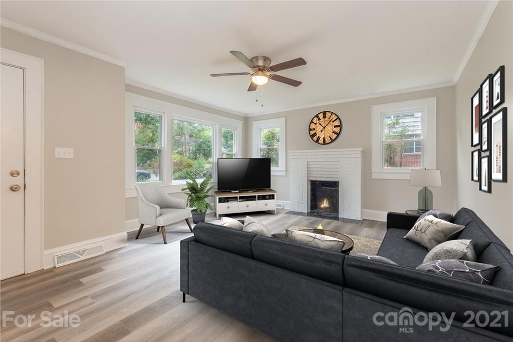 113 Hillside Avenue Southwest Concord, NC 28025 - Photo 4 of 19 a living room with furniture a fireplace and a large window