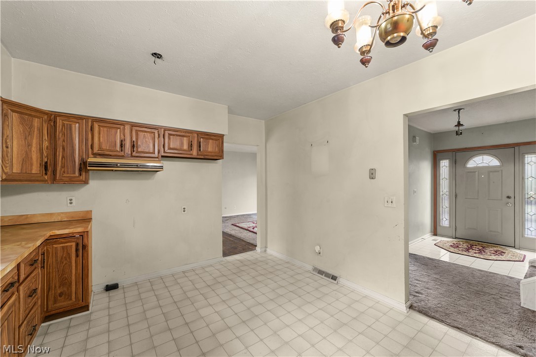 18763 Sharon Road Chagrin Falls, OH 44023 - Photo 23 of 37 Kitchen featuring an inviting chandelier and light carpet