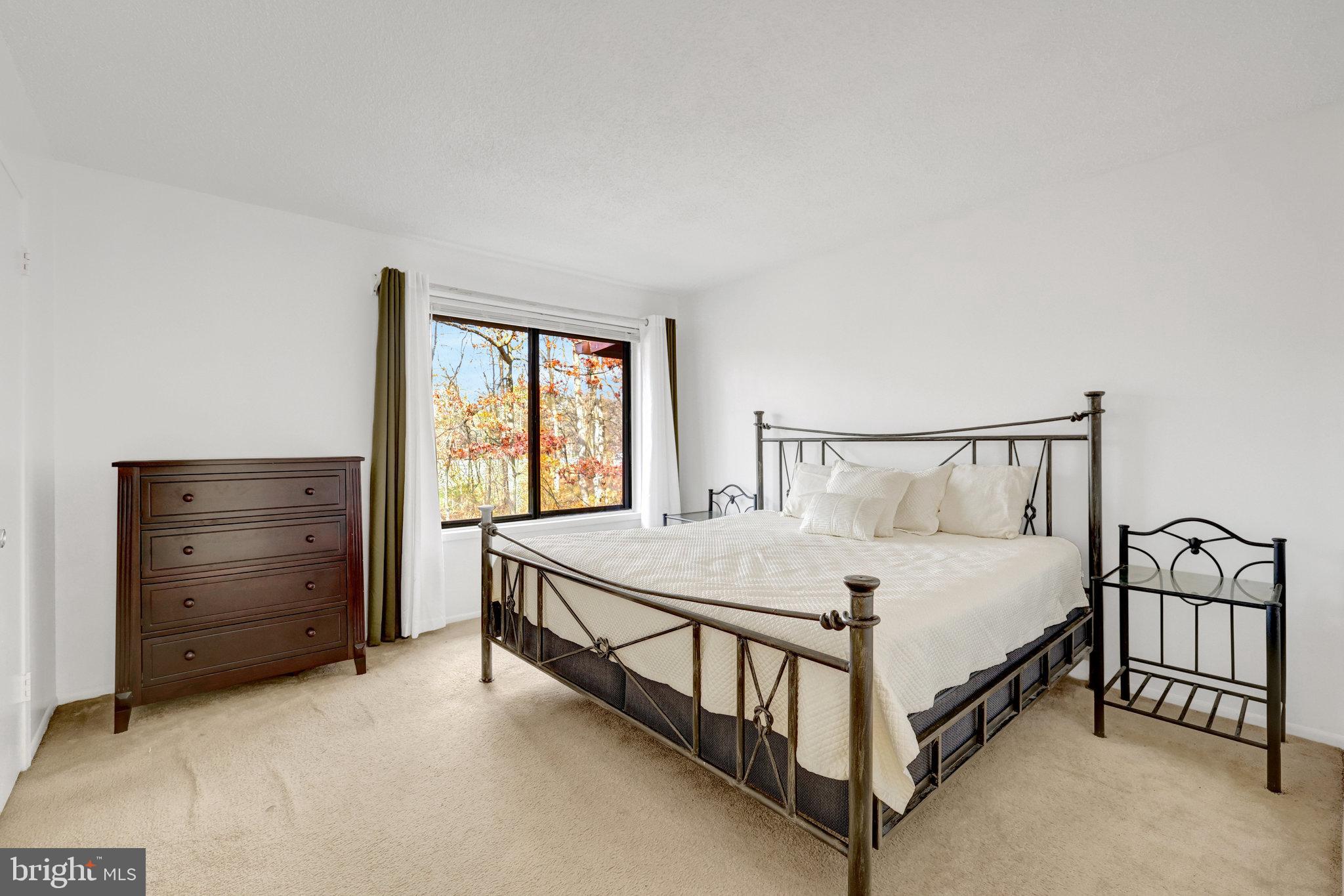 2142 Cartwright Place Reston, VA 20191 - Photo 21 of 46 a bed sitting in a bedroom next to a window with a dresser