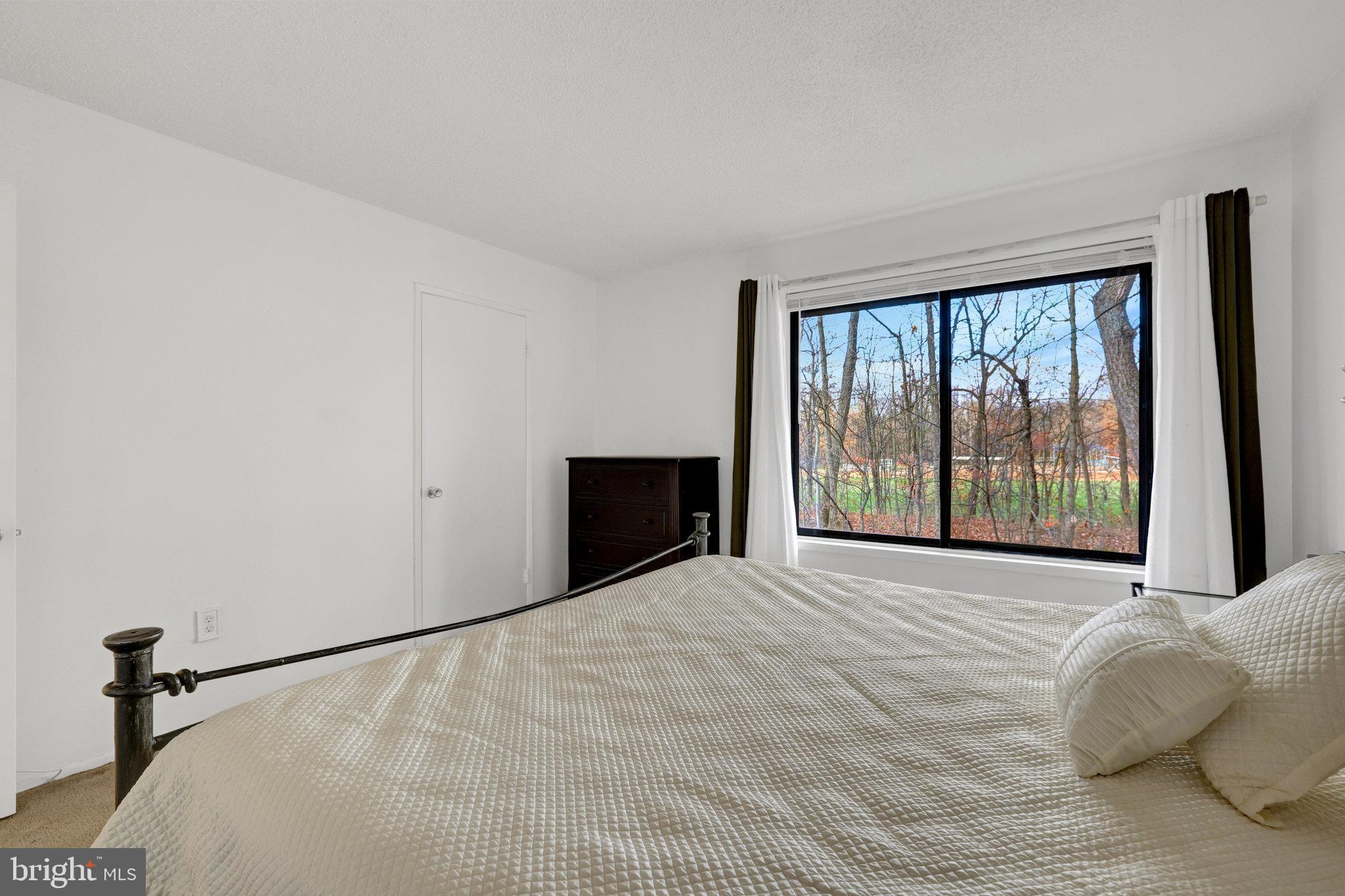 2142 Cartwright Place Reston, VA 20191 - Photo 22 of 46 a large white bed sitting in a room next to a window