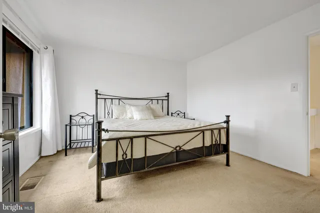 a bedroom with furniture and a window