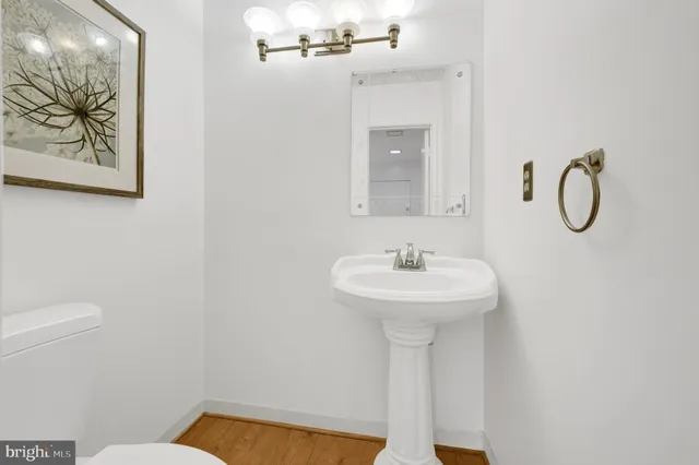 a bathroom with a sink a toilet and mirror