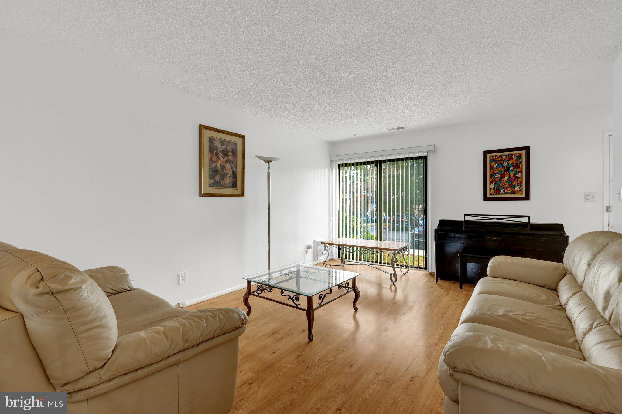 2142 Cartwright Place Reston, VA 20191 - Photo 7 of 46 a living room with furniture and a fireplace