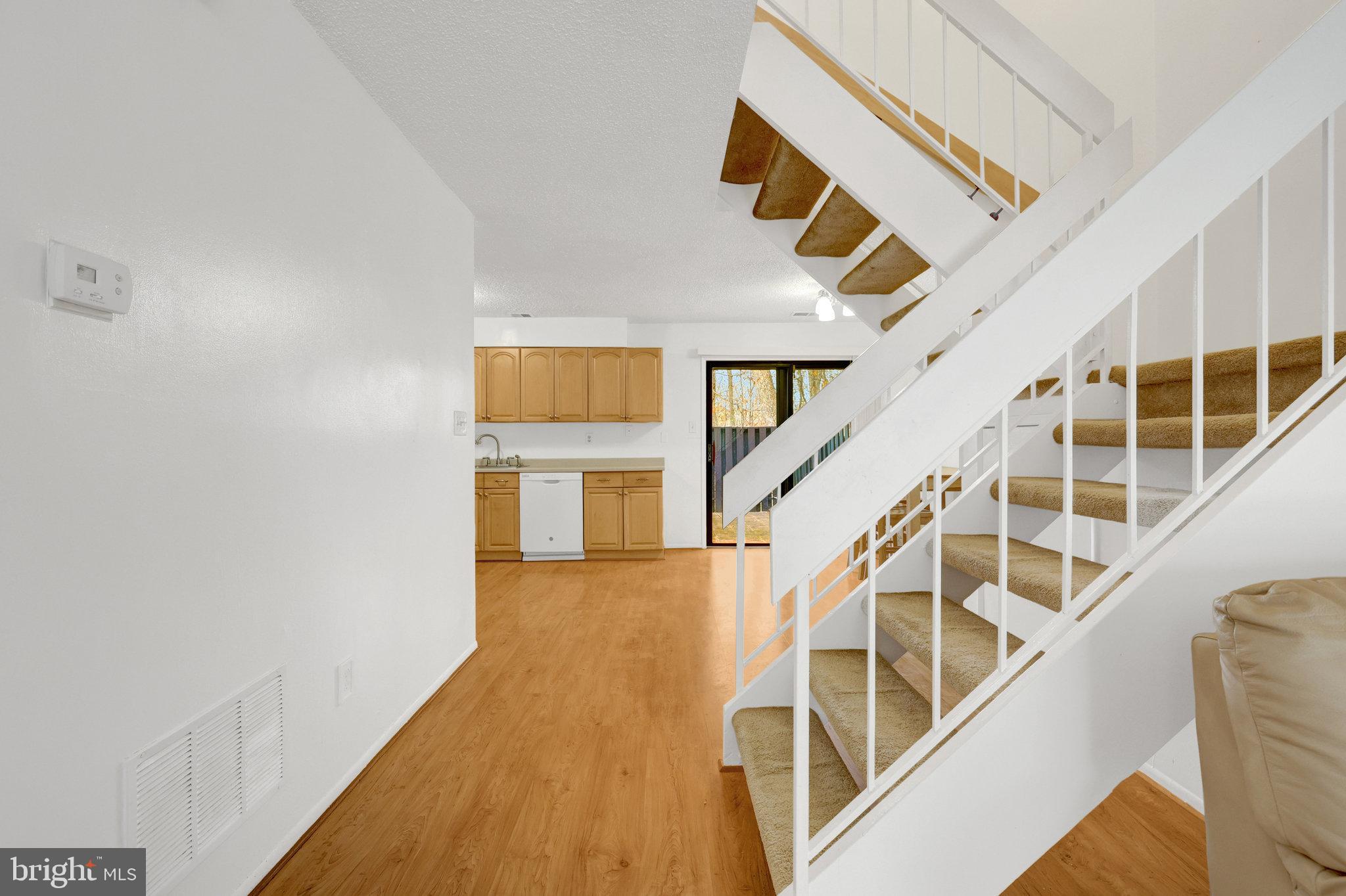 2142 Cartwright Place Reston, VA 20191 - Photo 9 of 46 a view of entryway and hall with wooden floor